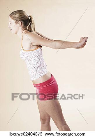 Young woman doing stretching exercises View Large Photo Image Stock Image - Young woman doing stretching exercises. Fotosearch