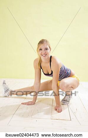 Stock Image - Young woman doing stretching exercises. Fotosearch
