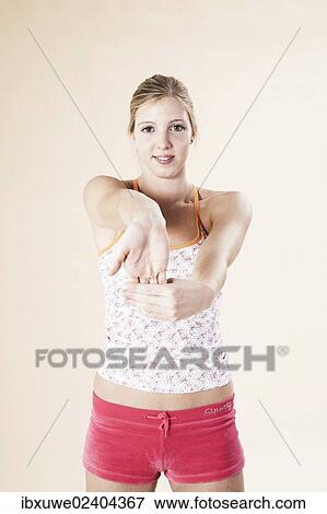 Young woman doing stretching exercises View Large Photo Image Stock Photo - Young woman doing stretching exercises. Fotosearch