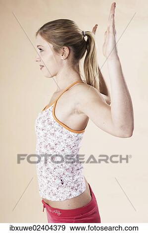 Stock Photo - Young woman doing stretching exercises. Fotosearch
