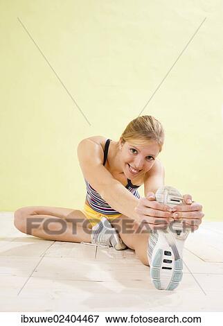 Stock Photo - Young woman doing stretching exercises. Fotosearch