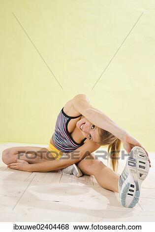 Young woman doing stretching exercises View Large Photo Image Stock Photo - Young woman doing stretching exercises. Fotosearch