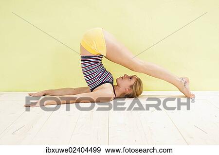 Stock Photo - Young woman doing stretching exercises. Fotosearch