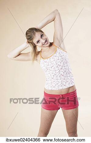 Young woman doing stretching exercises View Large Photo Image Stock Photograph - Young woman doing stretching exercises. Fotosearch