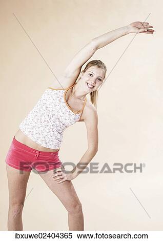 Young woman doing stretching exercises View Large Photo Image Stock Photography - Young woman doing stretching exercises. Fotosearch