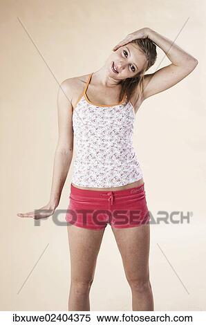 Young woman doing stretching exercises View Large Photo Image Stock Photography - Young woman doing stretching exercises. Fotosearch