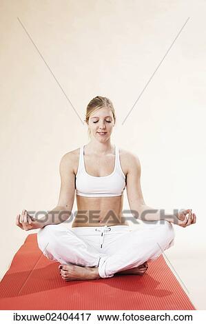 Young woman doing yoga View Large Photo Image Stock Photo - Young woman doing yoga. Fotosearch