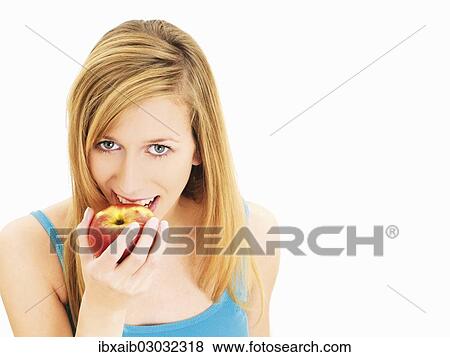 Stock Photo - Young woman eating an apple. Fotosearch