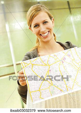 Young woman holding a city map at a U-Bahn metro station View Large Photo Image Stock Photo - Young woman holding a city map at a U-Bahn metro station. Fotosearch
