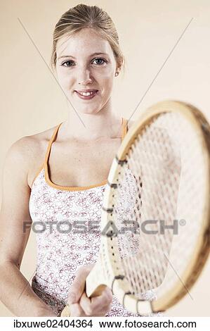 Young woman holding a tennis racket View Large Photo Image Picture - Young woman holding a tennis racket. Fotosearch