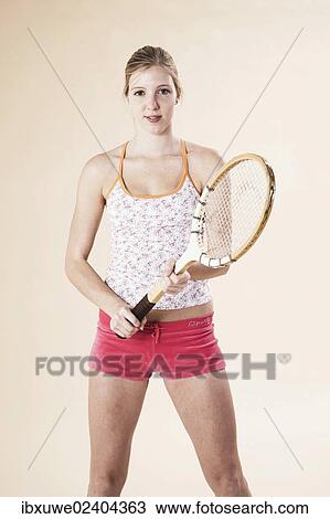 Young woman holding a tennis racket View Large Photo Image Stock Image - Young woman holding a tennis racket. Fotosearch