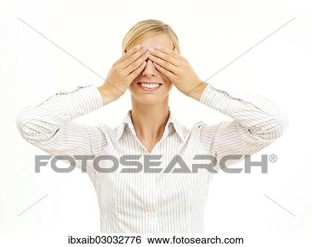 Stock Photograph - Young woman holding her hands over her eyes. Fotosearch