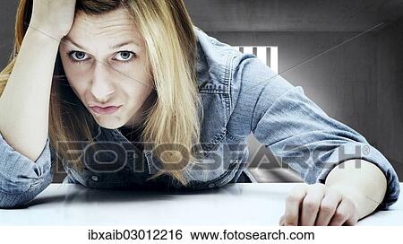Stock Photograph - Young woman in a jail cell. Fotosearch