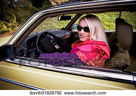 Young woman in a post-war classic car View Large Photo Image Stock Image - Young woman in a post-war classic car. Fotosearch