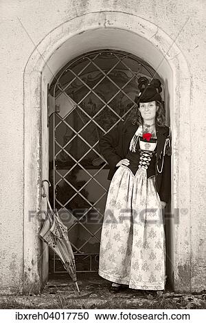 Stock Image - "Young woman in traditional costume, typical for the region Achensee Tyrolean traditional costume, Achenkirch, Tyrol, Austria, Europe". Fotosearch