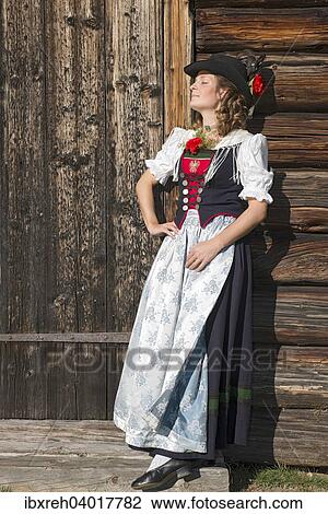 Stock Image - "Young woman in traditional costume, Tyrolean traditional costume typical for the region Achensee, Pertisau am Achensee, Tyrol, Austria, Europe". Fotosearch
