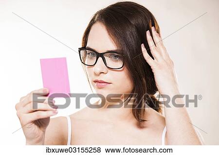 "Young woman looking at herself in a cosmetic mirror, Mannheim, Baden-Wurttemberg, Germany, Europe" View Large Photo Image Stock Photo - "Young woman looking at herself in a cosmetic mirror, Mannheim, Baden-Wurttemberg, Germany, Europe". Fotosearch