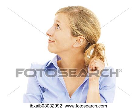 Stock Image - Young woman looking bashful. Fotosearch