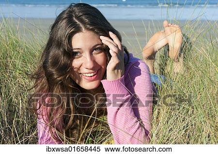 "Young woman lying in the dunes on the beach, Brittany region, France, Europe" View Large Photo Image Stock Photography - "Young woman lying in the dunes on the beach, Brittany region, France, Europe". Fotosearch