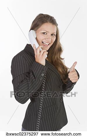 Young woman making a phone call View Large Photo Image Stock Photo - Young woman making a phone call. Fotosearch