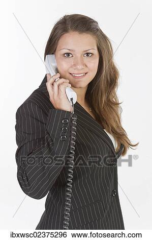 Young woman making a phone call View Large Photo Image Stock Photograph - Young woman making a phone call. Fotosearch