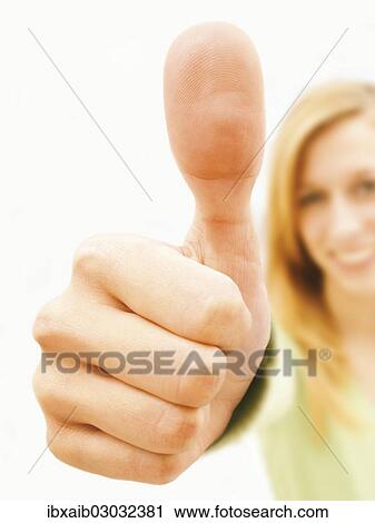 Young woman making a thumbs up gesture View Large Photo Image Stock Image - Young woman making a thumbs up gesture. Fotosearch