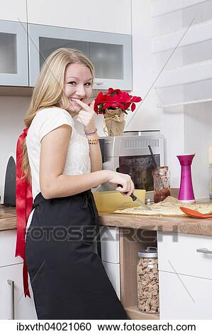 Young woman making Christmas cookies at home View Large Photo Image Stock Image - Young woman making Christmas cookies at home. Fotosearch