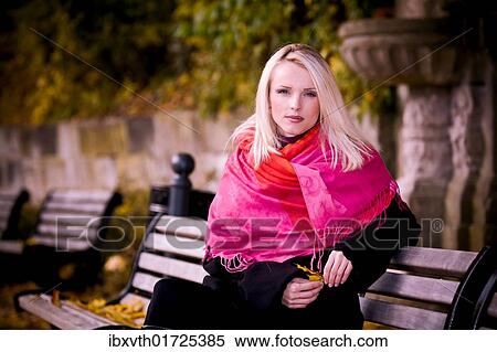Young woman on a bench in the park in autumn View Large Photo Image Stock Photography - Young woman on a bench in the park in autumn. Fotosearch