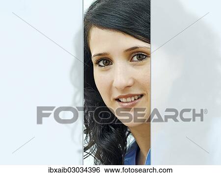 Stock Photograph - "Young woman, portrait, behind glass". Fotosearch