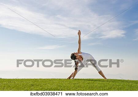 "Young woman practising Hatha yoga, here the pose utthita parshvakonasana, side stretch" View Large Photo Image Stock Image - "Young woman practising Hatha yoga, here the pose utthita parshvakonasana, side stretch". Fotosearch