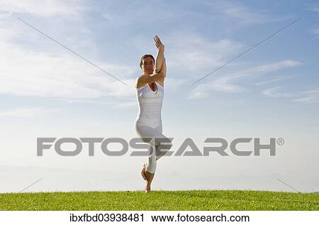 "Young woman practising Hatha yoga, here the pose Garudasana, eagle pose" View Large Photo Image Stock Image - "Young woman practising Hatha yoga, here the pose Garudasana, eagle pose". Fotosearch
