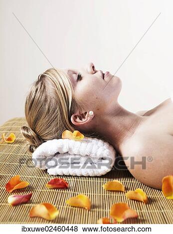 Young woman relaxing on her back View Large Photo Image Stock Photo - Young woman relaxing on her back. Fotosearch