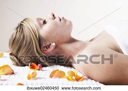 Young woman relaxing while lying on her back View Large Photo Image Stock Image - Young woman relaxing while lying on her back. Fotosearch