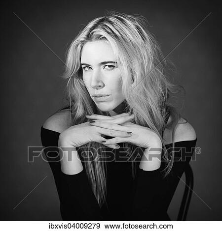 Stock Photo - Young woman showing expression of cool attitude. Fotosearch