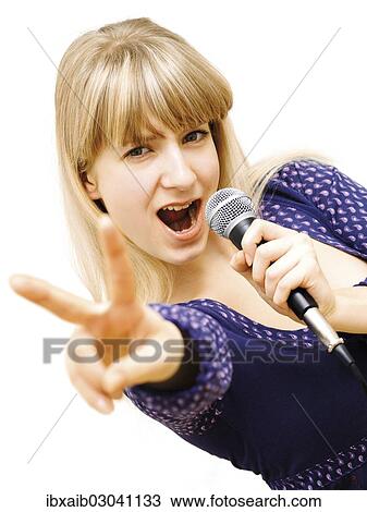 "Young woman singing into a microphone, making a V-sign" View Large Photo Image Stock Image - "Young woman singing into a microphone, making a V-sign". Fotosearch
