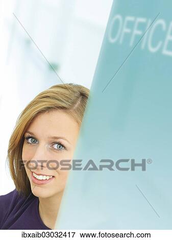 "Young woman smiling, in an office" View Large Photo Image Stock Photo - "Young woman smiling, in an office". Fotosearch