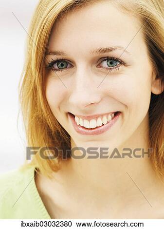 Stock Image - "Young woman smiling, portrait". Fotosearch