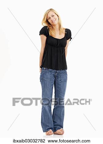 Stock Image - "Young woman, smiling, standing". Fotosearch