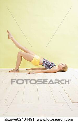 Young woman stabilising her torso View Large Photo Image Stock Image - Young woman stabilising her torso. Fotosearch