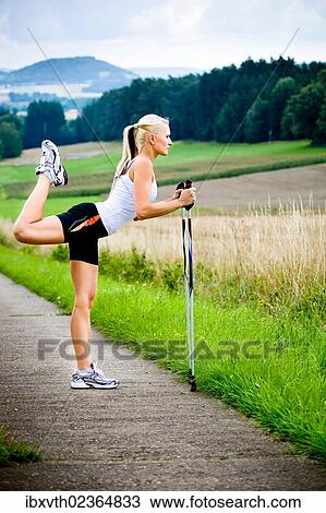 "Young woman stretching, nordic walking" View Large Photo Image Stock Image - "Young woman stretching, nordic walking". Fotosearch