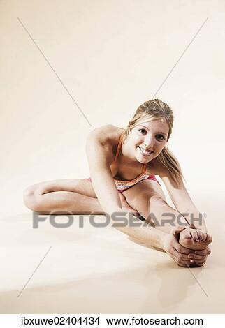 Young woman stretching View Large Photo Image Picture - Young woman stretching. Fotosearch