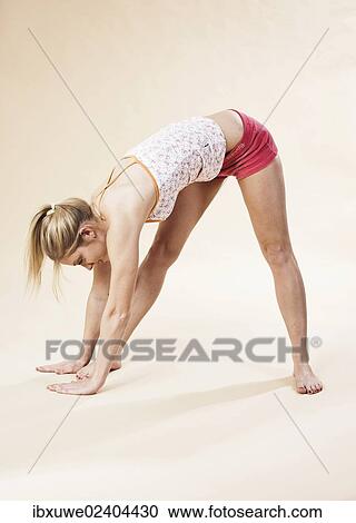 Young woman stretching View Large Photo Image Stock Image - Young woman stretching. Fotosearch