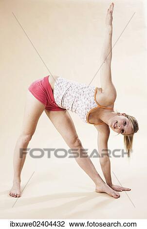 Young woman stretching View Large Photo Image Stock Image - Young woman stretching. Fotosearch