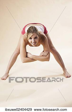 Stock Photo - Young woman stretching. Fotosearch