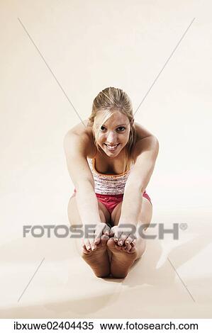 Young woman stretching View Large Photo Image Stock Photography - Young woman stretching. Fotosearch