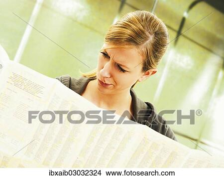 Picture - Young woman studying a city map at a U-Bahn metro station. Fotosearch