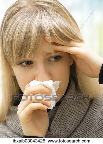 "Young woman using a tissue, blowing her nose, sick, allergy" View Large Photo Image Stock Photograph - "Young woman using a tissue, blowing her nose, sick, allergy". Fotosearch