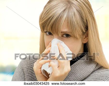 "Young woman using a tissue, blowing her nose, sick, allergy" View Large Photo Image Stock Photography - "Young woman using a tissue, blowing her nose, sick, allergy". Fotosearch