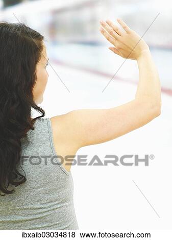 Young woman waving at a subway station View Large Photo Image Stock Photo - Young woman waving at a subway station. Fotosearch