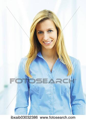Stock Photograph - Young woman wearing a blue blouse. Fotosearch